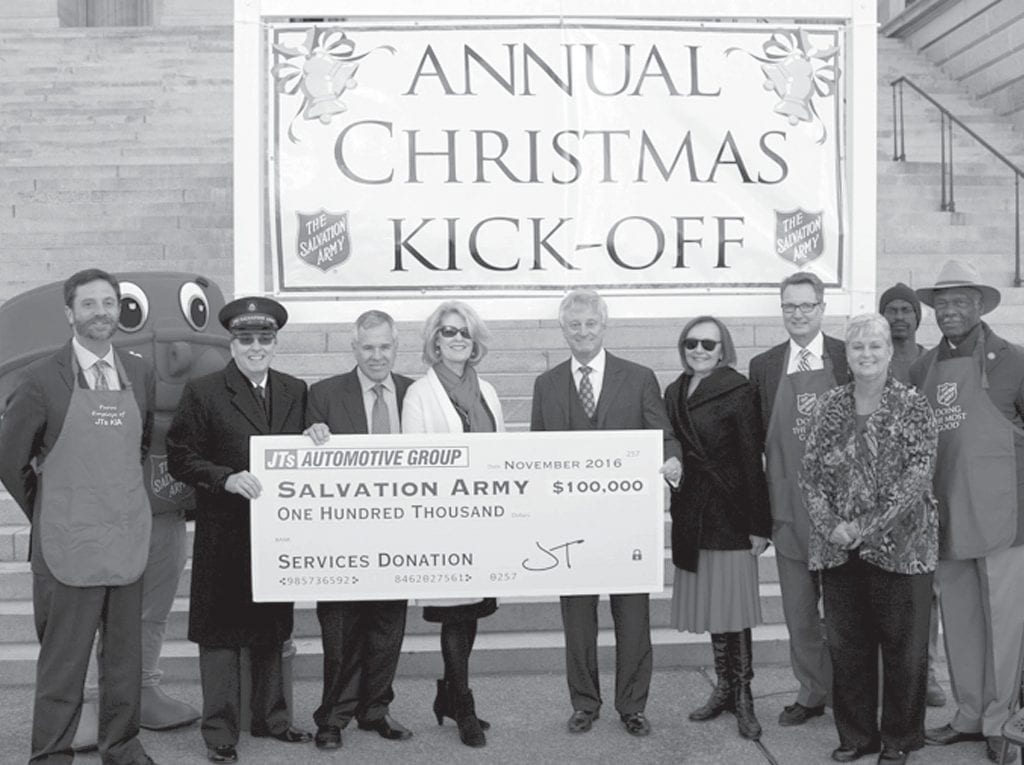 John T. Gandolfo with a group of people holding a check for $100,000 to donate to the Salvation Army at the annual Christmas kick-off.